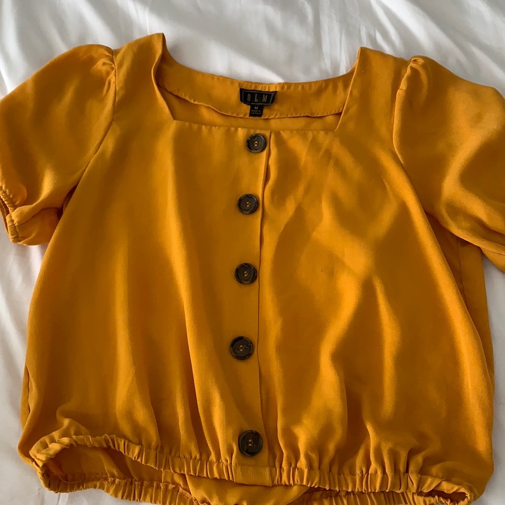 Mustard-colored blouse.